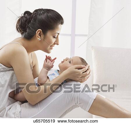 Stock Photo - Mother holding her baby . Fotosearch