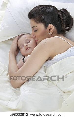 Mother sleeping with her baby View Large Photo Image Stock Image - Mother sleeping with her baby . Fotosearch