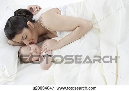 Mother sleeping with her baby View Large Photo Image Stock Photo - Mother sleeping with her baby . Fotosearch
