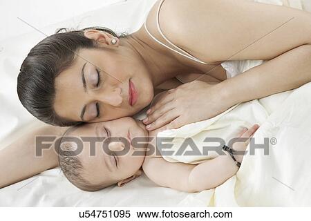 Mother sleeping with her baby View Large Photo Image Stock Photography - Mother sleeping with her baby . Fotosearch