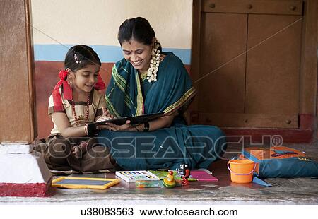 Stock Image - Mother teaching her daughter . Fotosearch