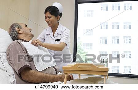 Stock Image - Nurse helping a patient . Fotosearch