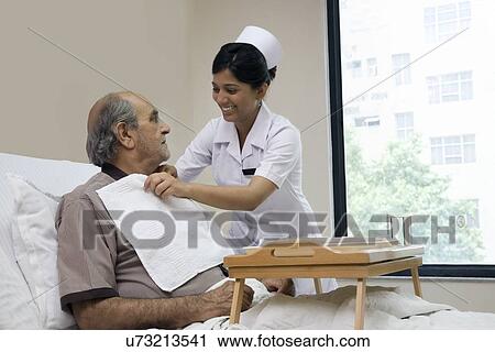Stock Image - Nurse helping a patient . Fotosearch