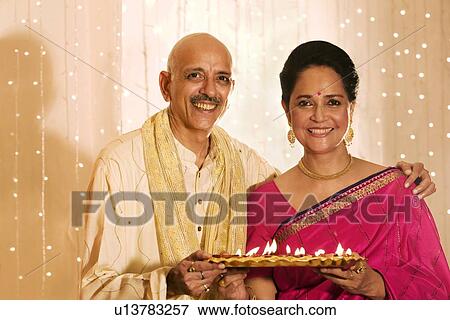 Old couple holding a tray with diyas View Large Photo Image Stock Photo - Old couple holding a tray with diyas . Fotosearch