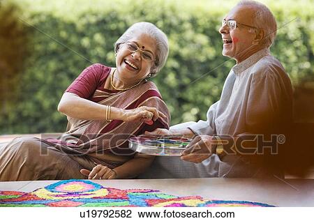 Old couple making a rangoli View Large Photo Image Stock Image - Old couple making a rangoli . Fotosearch