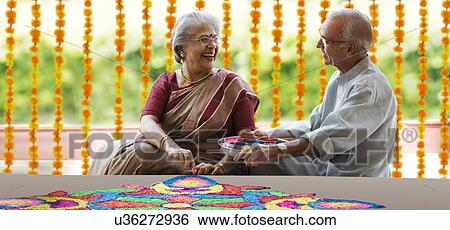 Old couple making a rangoli View Large Photo Image Stock Photograph - Old couple making a rangoli . Fotosearch