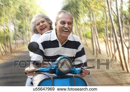 Old couple on a scooter View Large Photo Image Stock Photo - Old couple on a scooter . Fotosearch