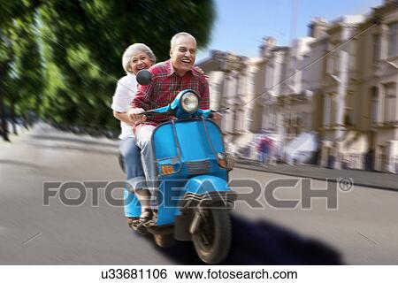 Old couple on a scooter View Large Photo Image Stock Photograph - Old couple on a scooter . Fotosearch