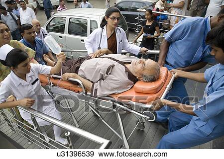 Patient going into a hospital on a stretcher View Large Photo Image Stock Photo - Patient going into a hospital on a stretcher . Fotosearch