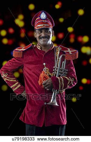 Portrait of a bandmaster holding a trumpet View Large Photo Image Stock Image - Portrait of a bandmaster holding a trumpet . Fotosearch