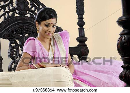 Portrait of a Bengali woman on a bed View Large Photo Image Picture - Portrait of a Bengali woman on a bed . Fotosearch