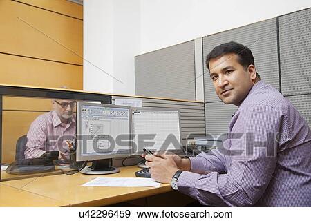 Stock Photo - Portrait of a business executive with a mobile phone. Fotosearch