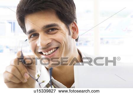 Stock Photo - Portrait of a businessman with spectacles . Fotosearch