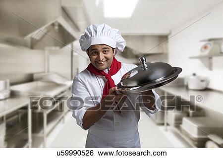 Portrait of a chef with a tray View Large Photo Image Stock Photograph - Portrait of a chef with a tray . Fotosearch