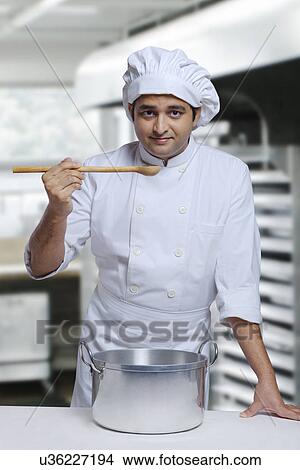 Portrait of a chef with a wooden spoon View Large Photo Image Picture - Portrait of a chef with a wooden spoon . Fotosearch