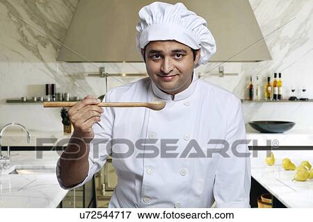 Portrait of a chef with a wooden spoon View Large Photo Image Stock Photo - Portrait of a chef with a wooden spoon . Fotosearch
