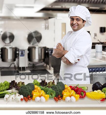 Portrait of a chef with his vegetables View Large Photo Image Stock Photo - Portrait of a chef with his vegetables . Fotosearch