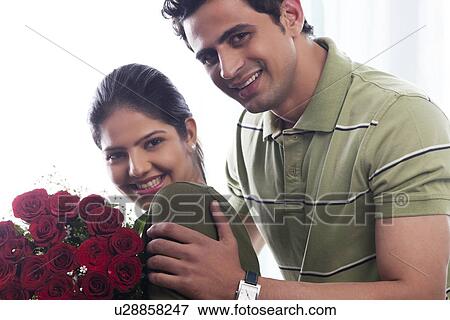 Portrait of a couple with a bouquet of roses View Large Photo Image Stock Photo - Portrait of a couple with a bouquet of roses. Fotosearch