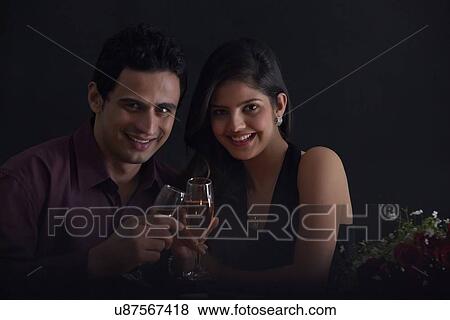 Stock Photo - Portrait of a couple with glasses of wine. Fotosearch