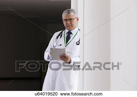 Stock Image - Portrait of a doctor with a digital tablet. Fotosearch