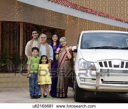 Portrait of a family standing next to a car View Large Photo Image Stock Image - Portrait of a family standing next to a car . Fotosearch