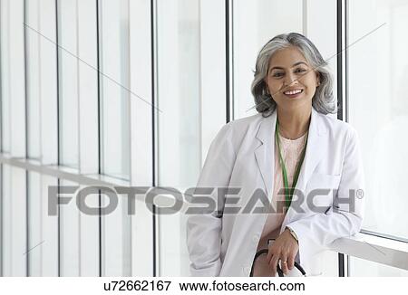 Stock Photo - Portrait of a female doctor smiling. Fotosearch