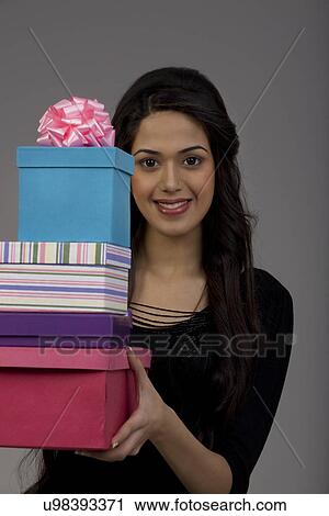 Portrait of a girl holding gifts View Large Photo Image Stock Image - Portrait of a girl holding gifts . Fotosearch
