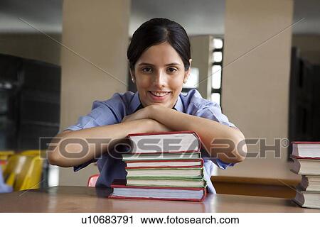 Portrait of a girl leaning on some books View Large Photo Image Stock Image - Portrait of a girl leaning on some books . Fotosearch