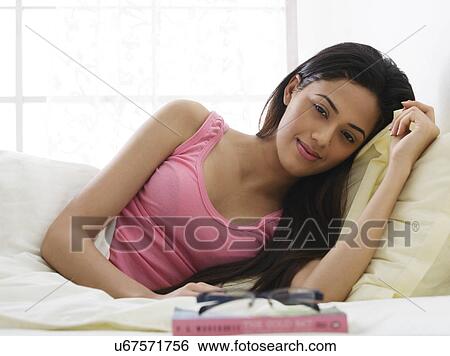 Portrait of a girl lying in bed View Large Photo Image Stock Photograph - Portrait of a girl lying in bed . Fotosearch