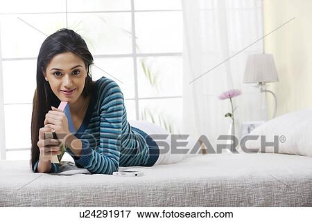 Portrait of a girl with a book in bed View Large Photo Image Stock Photo - Portrait of a girl with a book in bed . Fotosearch