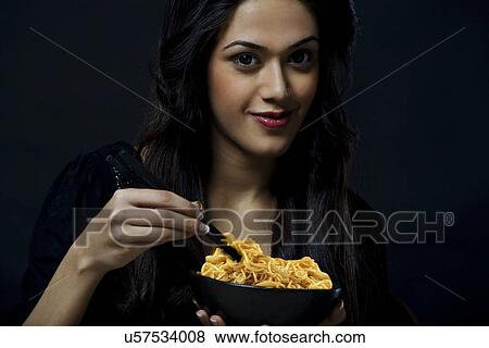 Portrait of a girl with a bowl of noodles View Large Photo Image Stock Photo - Portrait of a girl with a bowl of noodles . Fotosearch