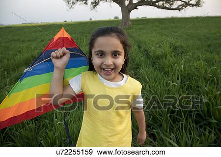Portrait of a girl with a kite View Large Photo Image Stock Photo - Portrait of a girl with a kite . Fotosearch
