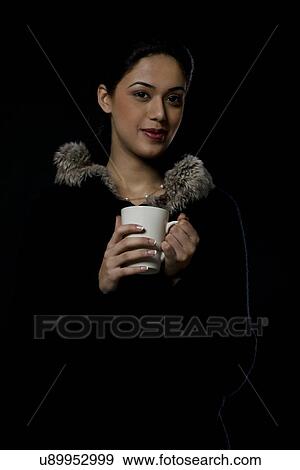 Stock Photo - Portrait of a girl with a mug of tea . Fotosearch