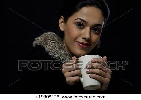 Stock Photograph - Portrait of a girl with a mug of tea . Fotosearch
