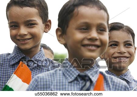 Portrait of a school boy holding the Indian flag View Large Photo Image Stock Image - Portrait of a school boy holding the Indian flag . Fotosearch