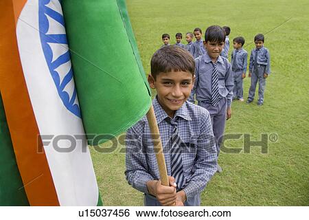 Portrait of a school boy holding the Indian flag View Large Photo Image Stock Photograph - Portrait of a school boy holding the Indian flag . Fotosearch