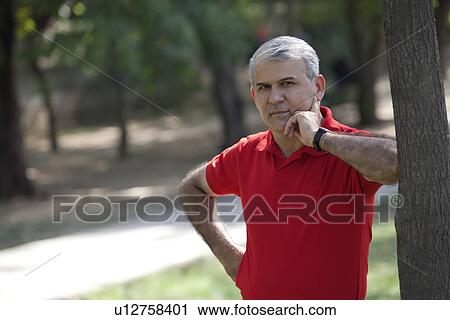 Portrait of a senior man in a park View Large Photo Image Stock Image - Portrait of a senior man in a park. Fotosearch