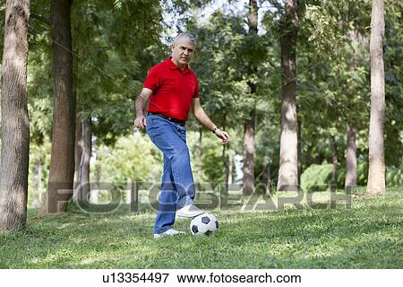 Portrait of a senior man playing soccer View Large Photo Image Stock Photo - Portrait of a senior man playing soccer. Fotosearch