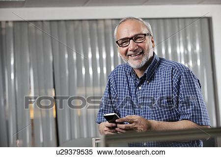 Portrait of a senior man with a mobile phone View Large Photo Image Stock Photography - Portrait of a senior man with a mobile phone. Fotosearch