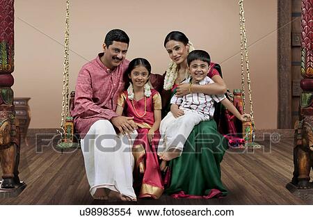 Portrait of a South Indian family sitting on a jhula View Large Photo Image Picture - Portrait of a South Indian family sitting on a jhula . Fotosearch