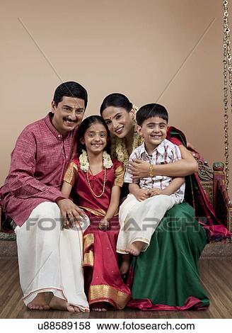 Stock Photo - Portrait of a South Indian family sitting on a jhula . Fotosearch