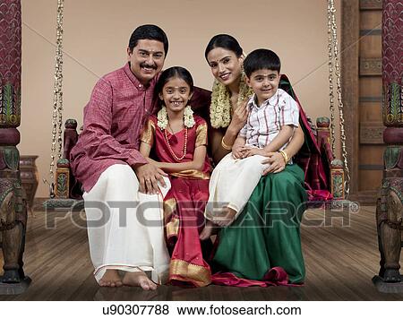 Portrait of a South Indian family sitting on a jhula View Large Photo Image Stock Photo - Portrait of a South Indian family sitting on a jhula . Fotosearch