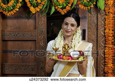 Portrait of a South Indian woman holding a tray View Large Photo Image Stock Image - Portrait of a South Indian woman holding a tray . Fotosearch