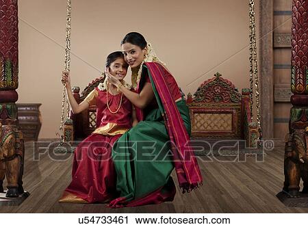 Portrait of a South Indian woman sitting with her daughter on a jhula View Large Photo Image Stock Image - Portrait of a South Indian woman sitting with her daughter on a jhula . Fotosearch