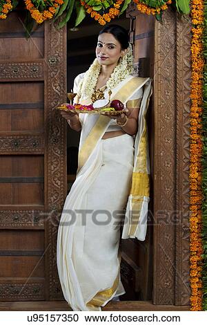 Portrait of a South Indian woman holding a tray View Large Photo Image Stock Image - Portrait of a South Indian woman holding a tray . Fotosearch