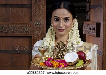 Portrait of a South Indian woman holding a tray View Large Photo Image Stock Photo - Portrait of a South Indian woman holding a tray . Fotosearch