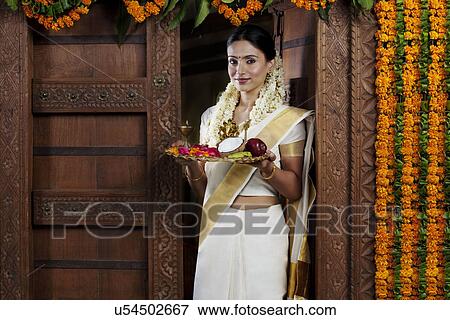 Portrait of a South Indian woman holding a tray View Large Photo Image Stock Photo - Portrait of a South Indian woman holding a tray . Fotosearch