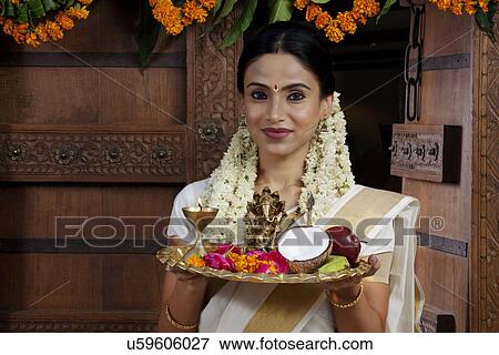 Stock Photo - Portrait of a South Indian woman holding a tray . Fotosearch