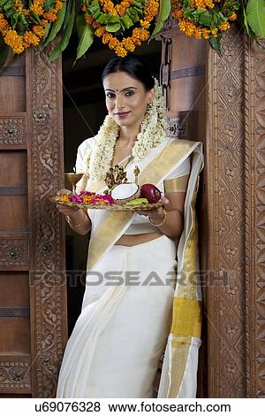Stock Photo - Portrait of a South Indian woman holding a tray . Fotosearch