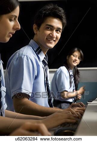Portrait of a student in a computer lab View Large Photo Image Picture - Portrait of a student in a computer lab . Fotosearch